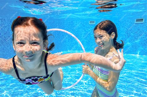 Premium Photo Happy Active Kids Play Underwater In Swimming Pool