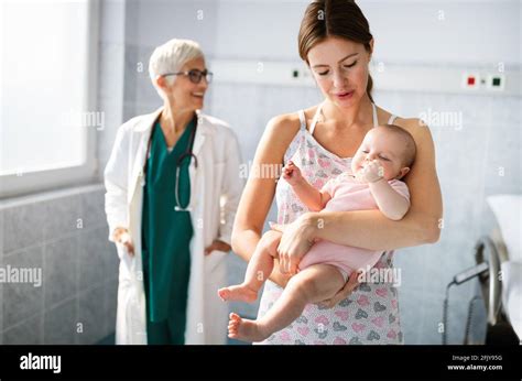 Beautiful Mother And Baby On Medical Examination With Doctor In