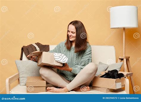 Satisfied Woman Shopaholic Customer Sitting On Sofa Unpack Parcel