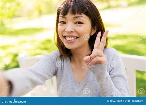 Happy Asian Woman Taking Selfie And Showing Peace Stock Photo Image