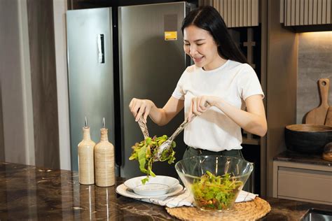 Asian Housewife Preparing Fresh Vegetables To Make Salad At Home