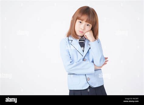 Elementary School Girl In School Uniforms With Short Hair Gesturing