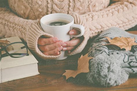 Cozy Home Woman Warming Up Her Hands With Coffee Mug Del Colaborador De Stocksy