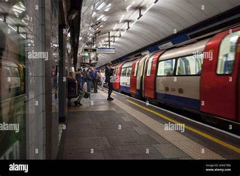 Passengers And Tube Train At Stockwell London Underground Station