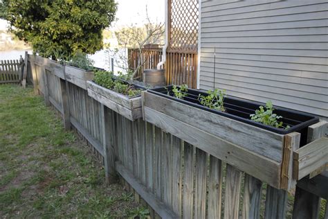 Placing flowering plants on a fence helps disguise a boring or downright ugly blank space while making the most of a. DIY Hanging Fence Planters