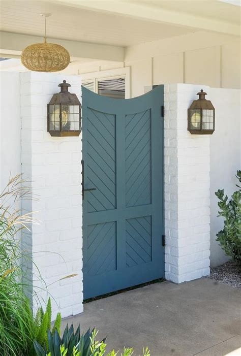 Blue wooden chevron gate door completed with oil rubbed bronze hardware