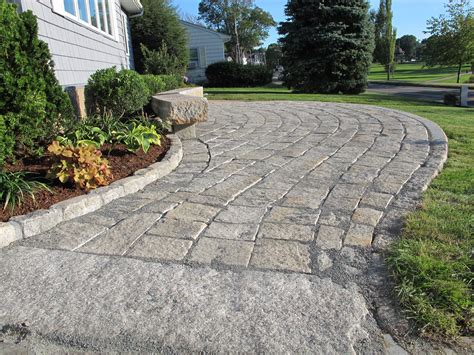 Reclaimed Granite Pavers And Cobblestone Edging Were Used In This Patio