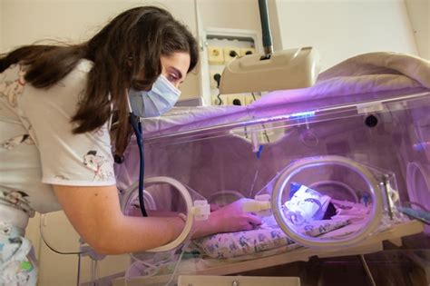 Premium Photo Female Doctor Examining Newborn Baby In Incubator