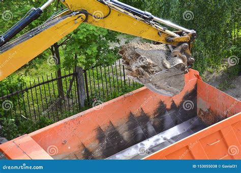 Heavy Machinery Working On Construction Site Excavator Loading Dump