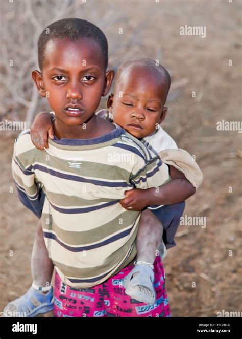 Brother With Sister On His Back In African Orphan Children Near Moashi