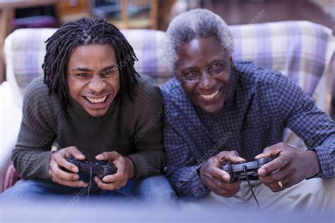 Happy Grandfather And Grandson Playing Video Game Stock Image F021