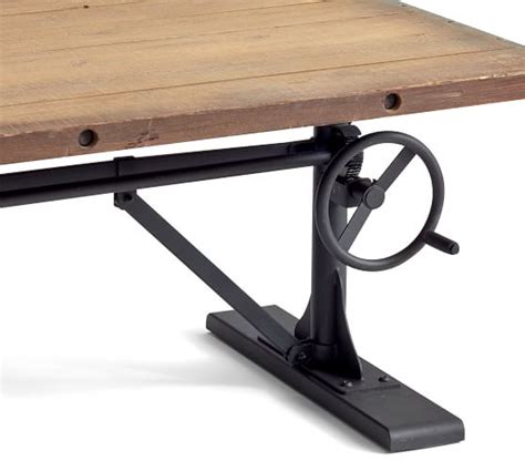 The iron base of our industrial crank drafting table is a feat in engineering with its functioning wheel and gear mechanisms that adjust the height and angle of the mango wood top. Pittsburgh Crank Coffee Table | Pottery Barn