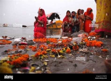 Hindu Devotees Offer Prayers To Suraya Dev On Rising Sun In The Waters