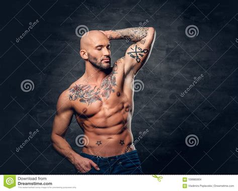 Shaved Head Muscular Male With Tattoos On His Torso Over Grey V Stock Photo Image Of Male