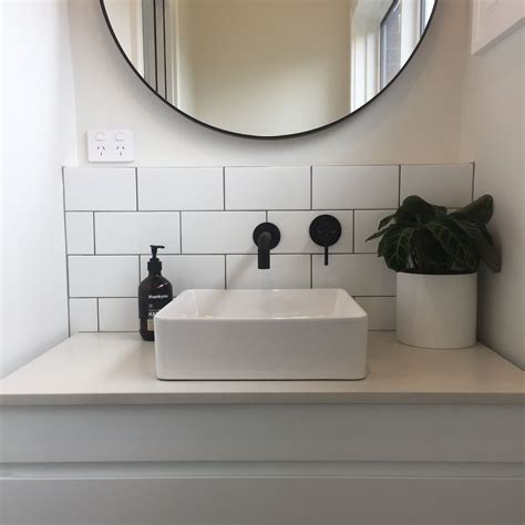 Every living room needs a sofa, every bedroom needs a bed and every bathroom needs a mirror. Powder room- subway tiles, matte black, round mirror ...
