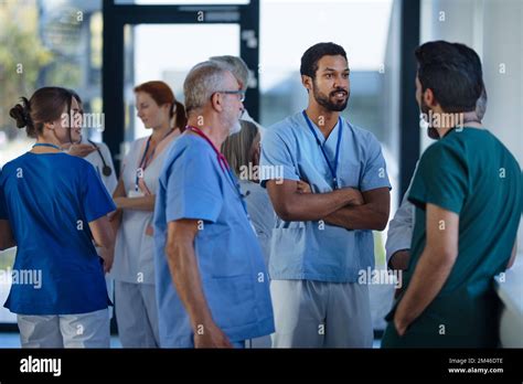 Doctors And Nurses Talking Together At Hospital Corridor Stock Photo