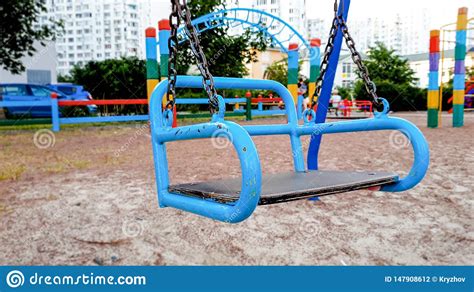 Closeup Image Of Empty Metal Swings On The Children Playground Stock