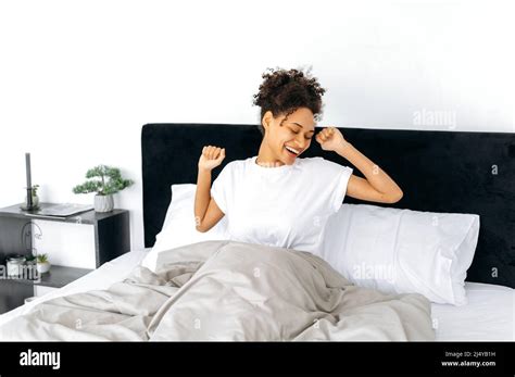 Morning Awakening Happy Lovely African American Curly Haired Girl In A White T Shirt Wakes Up