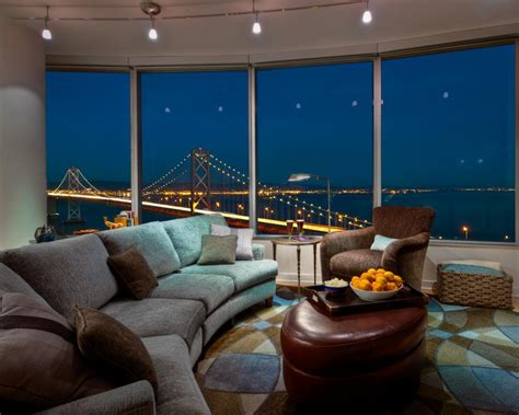 Brushed metal decorative cat accent piece. Contemporary Curved Living Room With Gorgeous Night View | HGTV