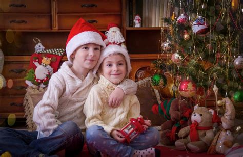 Sister And Brother Hugging Under Christmas Tree Stock Image Image Of