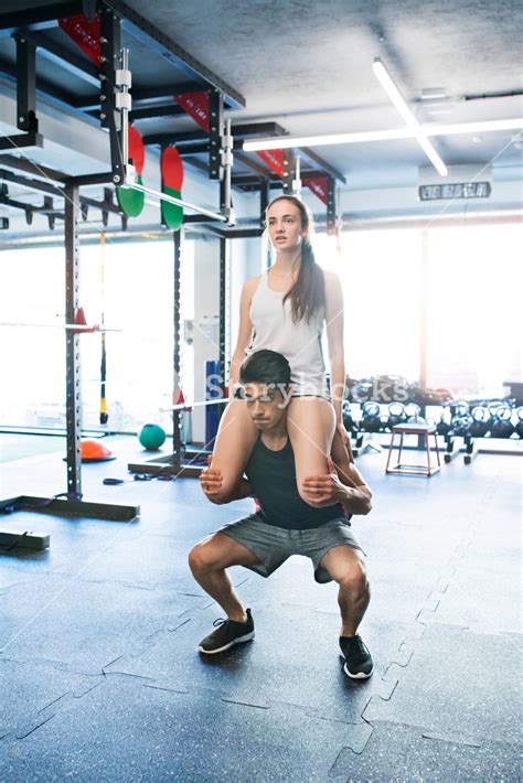 Fit Couple In Modern Gym Doing Partner Squats Royalty Free Stock Image Storyblocks