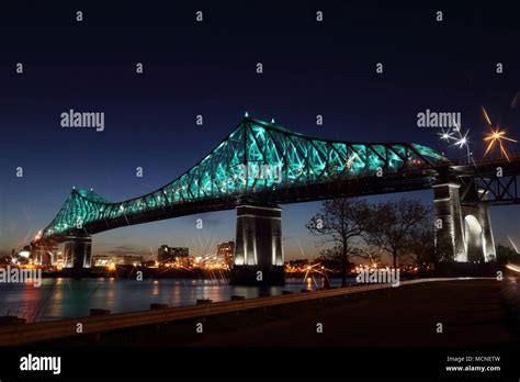 Jacques Cartier Bridge Illumination In Montreal Reflection In Water