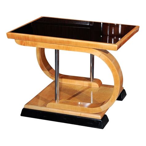 The coffee tables of these times enjoyed the use of darker woods, such as walnut and mahogany, modern metals and glass. Unusual Art Deco Asymmetrical coffee table at 1stdibs