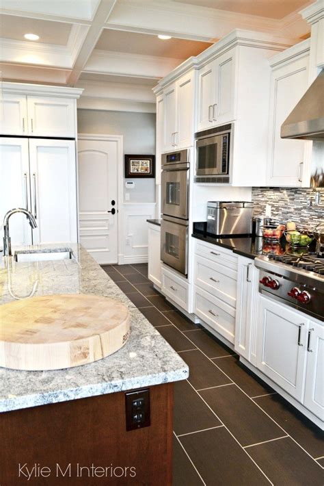 Dark tile kitchen floor white cabinets. Marble island with dark porcelain tile flooring, white ...