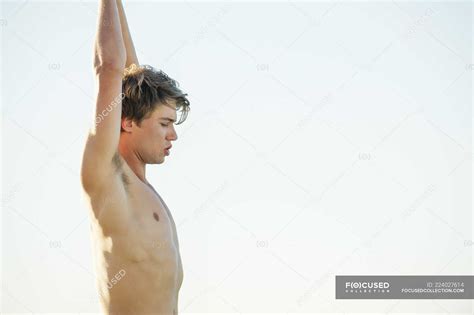 Shirtless Man Standing With Arms Raised Outdoors Caucasian Ethnicity