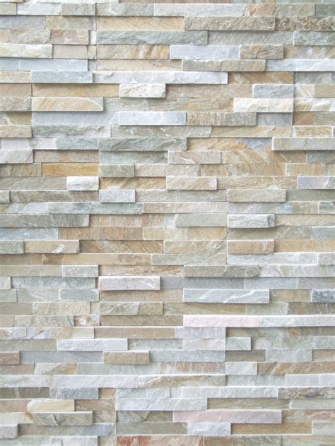 The grey upholstered headboard in this modern bedroom has angular panels with hidden lighting between them to give the bedroom a soft glow. BRAZILLIAN QUARTZITE STACK STONE CLADDING