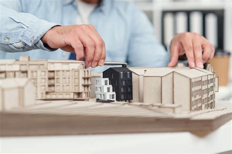 Premium Photo Close Up Architects Hands At Constructing Model Of