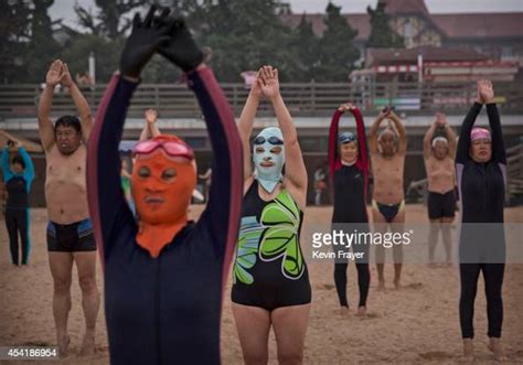 Chinese Women Wear Face Kinis As They Exercise On The Beach On August