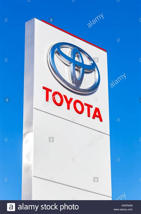 Official Dealership Sign Of Toyota Against The Blue Sky Background