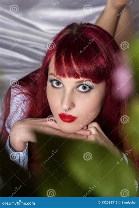 sensual woman resting on a bed in hotel room redhead girl wearing only a shirt stock image