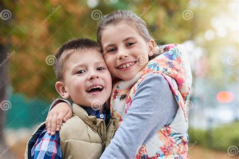 Happy Siblings Hugging Outside Stock Image Image Of Love Happy 84010613