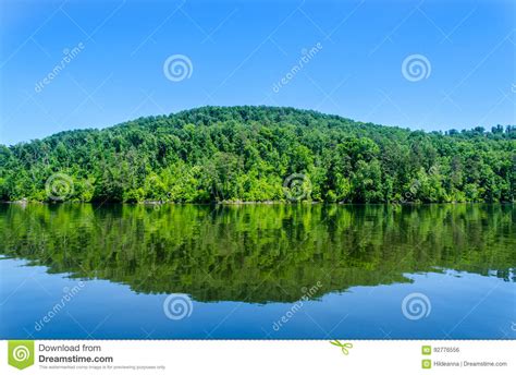 Reflections Of Lush Green Hills In Blue Lake Water Stock Photo Image