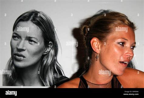 Kate Moss Stands Before A Series Of Portraits By Corinne Day At The
