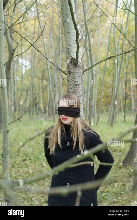 Young Woman Is Tied Up And Blindfolded In The Forest Stock Photo Alamy