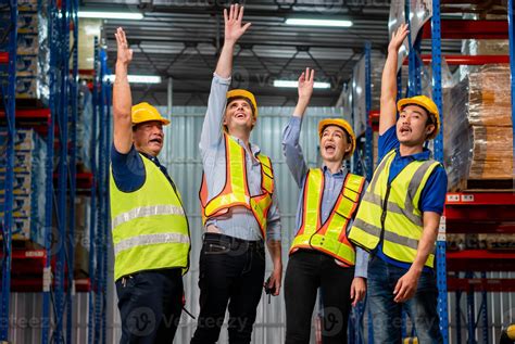 Successful warehouse workers team punching the air in celebration