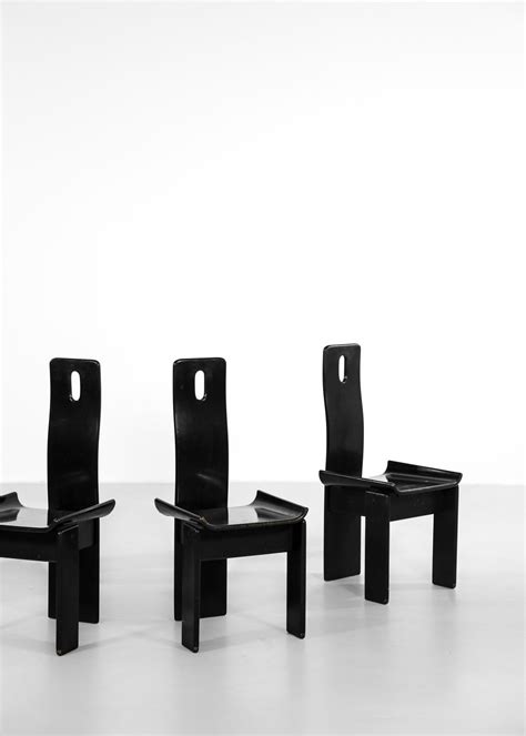 Three Black Chairs Sitting Next To Each Other