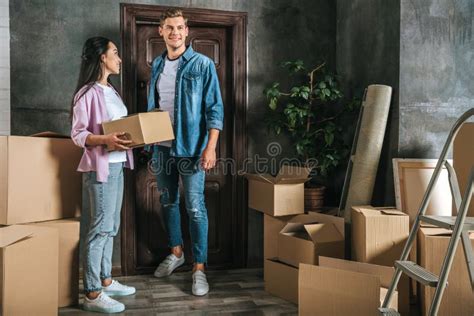 Happy Young Couple With Lot Of Boxes Moving Into Stock Photo Image Of