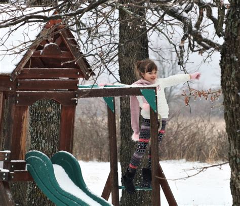 Little Girl On Snow Covered Playset Free Stock Photo Public Domain