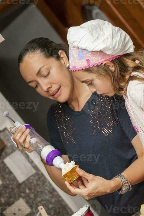 Mother And Daughter Having Fun In The Kitchen Baking Together Preparing Cupcakes With Mom