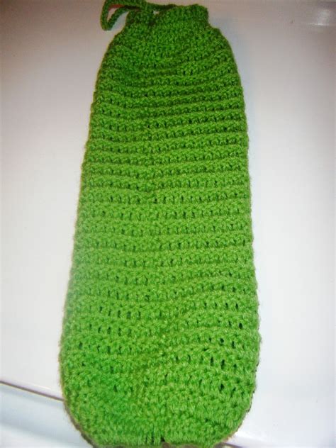 Plus, kitchen towels come in a variety of colors and patterns—your bag holder will be pretty as well as functional! The Craftivist: Crochet Plastic Bag Holder
