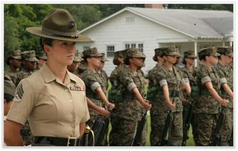 A Group Of Women In Uniform Standing Next To Each Other Near A House
