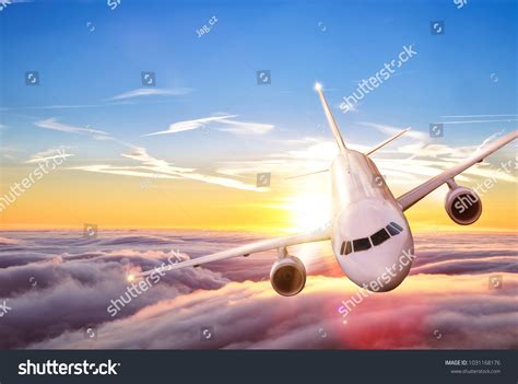 Commercial Airplane Jetliner Flying Above Clouds Stock Photo 1031168176