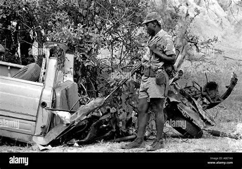 A Rhodesian Soldier Checks Out The Damage Done To A Truck Hit By A