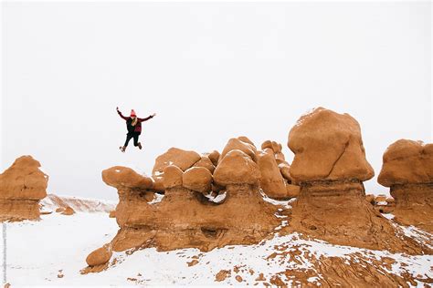 Girl Jumping On Top Of Rocks Covered In Now By Stocksy Contributor Laura Austin Stocksy