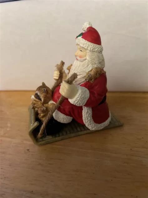 Santa On Toboggan Sled With Raccoon And Squirrels Figurine 1000