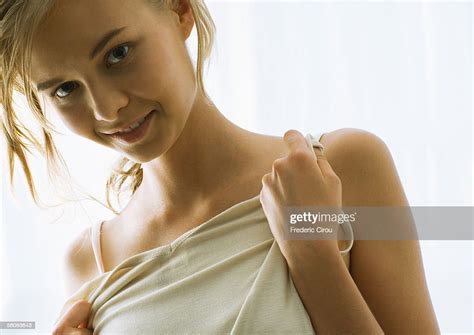 Young Woman Holding Up Shirt To Chest ストックフォト Getty Images